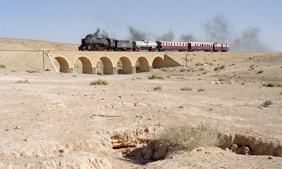 Steam locomotive 51 & train cross a wadi, heading north from Qatrana to Amman, Hedjaz Railway, Jordan