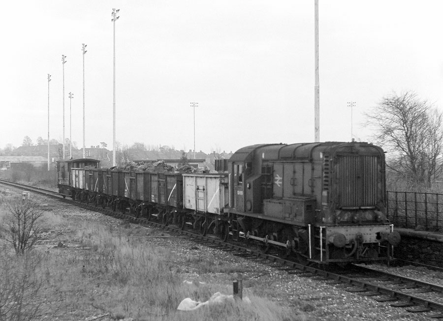 0-6-0 diesel shunter no. 08619 propels wagons of scrap from the ex-Great Central goods yard towards Knighton Junction on the Burton to Leicester line