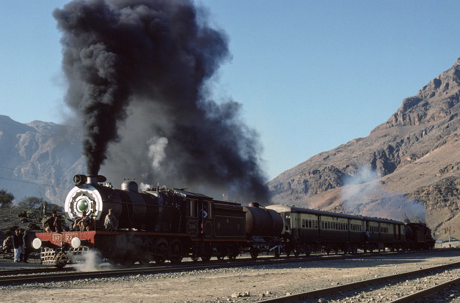Broad gauge, oil fired, class HGS 2-8-0 locomotives perform a runpast with a charter train at Shahgai, on the Khyber Pass, 23rd December 1993