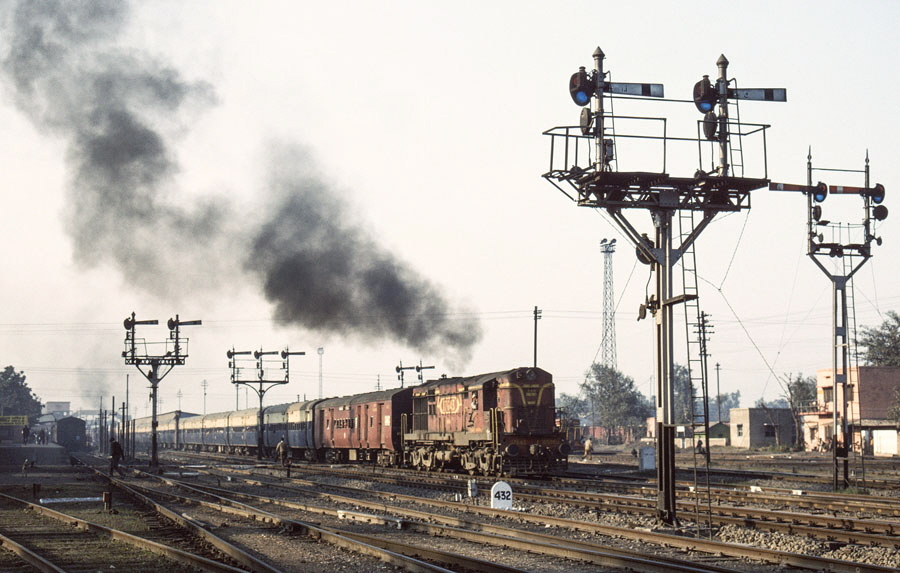 Broad gauge, steam locomotive, class WL 4-6-2 15051 departs Jalandhar station, India, with a local passenger train, 25th December 1993.